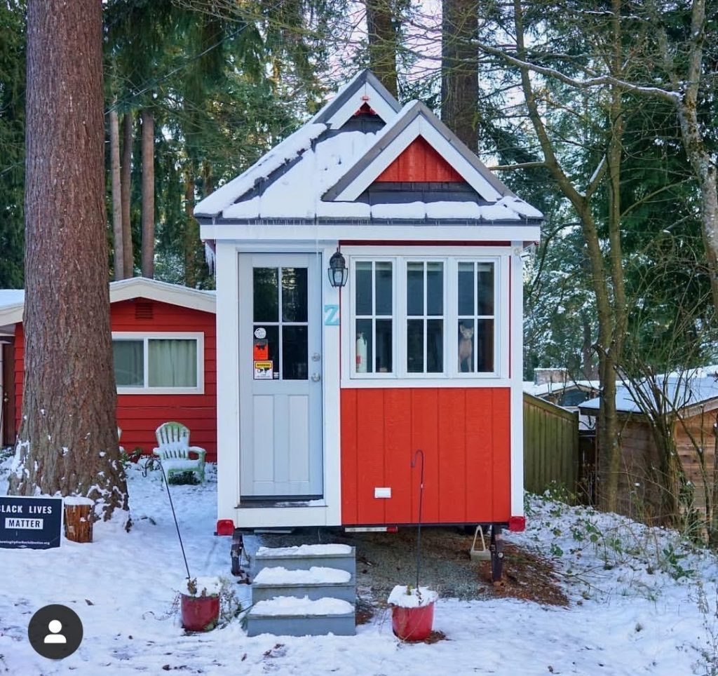 Red tiny house in the snow